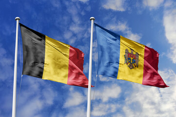 3d illustration. Belgium and Moldova Flag waving in sky. High detailed waving flag. 3D render. Waving in sky. Flags fluttered in the cloudy sky.