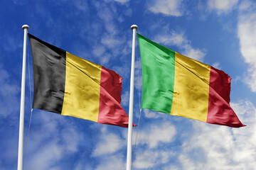 3d illustration. Belgium and Mali Flag waving in sky. High detailed waving flag. 3D render. Waving in sky. Flags fluttered in the cloudy sky.