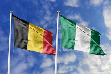 3d illustration. Belgium and Nigeria Flag waving in sky. High detailed waving flag. 3D render....