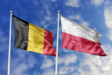3d illustration. Belgium and Poland Flag waving in sky. High detailed waving flag. 3D render. Waving in sky. Flags fluttered in the cloudy sky.