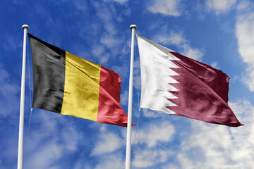 3d illustration. Belgium and Qatar Flag waving in sky. High detailed waving flag. 3D render. Waving in sky. Flags fluttered in the cloudy sky.