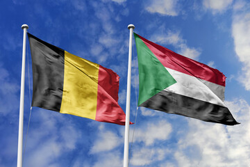 3d illustration. Belgium and Sudan Flag waving in sky. High detailed waving flag. 3D render. Waving in sky. Flags fluttered in the cloudy sky.