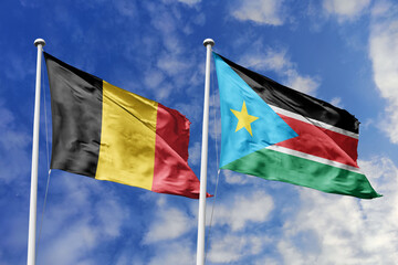 3d illustration. Belgium and South Sudan Flag waving in sky. High detailed waving flag. 3D render. Waving in sky. Flags fluttered in the cloudy sky.