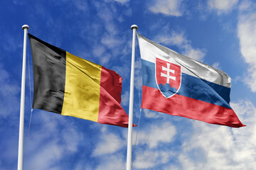 3d illustration. Belgium and Slovakia Flag waving in sky. High detailed waving flag. 3D render. Waving in sky. Flags fluttered in the cloudy sky.