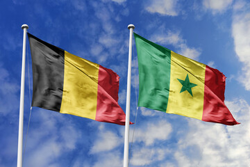 3d illustration. Belgium and Senegal Flag waving in sky. High detailed waving flag. 3D render. Waving in sky. Flags fluttered in the cloudy sky.