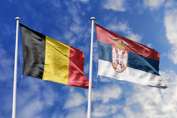 3d illustration. Belgium and Serbia Flag waving in sky. High detailed waving flag. 3D render....