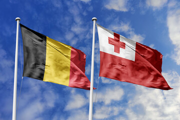 3d illustration. Belgium and Tonga Flag waving in sky. High detailed waving flag. 3D render. Waving in sky. Flags fluttered in the cloudy sky.
