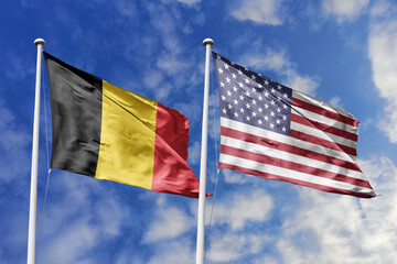 3d illustration. Belgium and United States Flag waving in sky. High detailed waving flag. 3D render. Waving in sky. Flags fluttered in the cloudy sky.