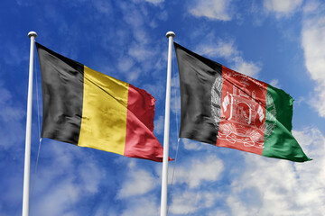3d illustration. Belgium and Afghanistan Flag waving in sky. High detailed waving flag. 3D render....