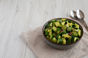 Homemade Smashed Cucumber Salad in a Bowl, side view. Copy space.