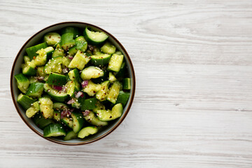 Homemade Smashed Cucumber Salad in a Bowl, top view. Space for text.