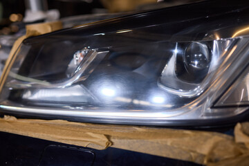 Person using a machine to polish automotive lighting on a car headlight