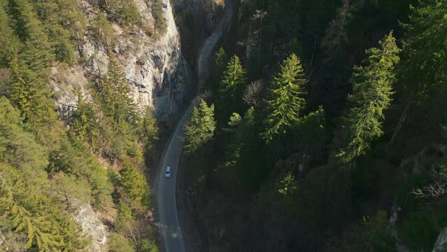 Drone of a car driving on the curved road in Bicaz Gorges Nature preserve in the mountains