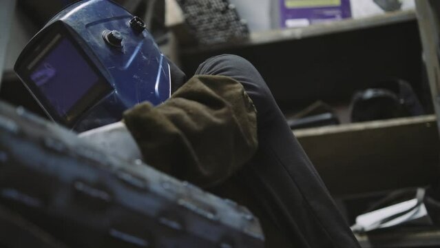 Artisan welding a piece of metal in his workshop.