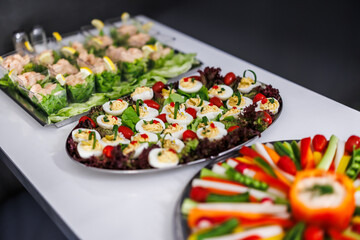 Colorful appetizer platters featuring deviled eggs and fresh vegetables