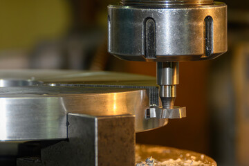 The T-slot cutting process on NC milling machine with T-slot cutter in the light blue scene.