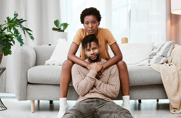 Portrait, black couple and love in living room, man and woman with hug, romance or relax in home...
