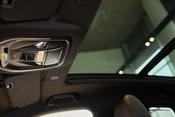Motor vehicle with sunroof, rear view mirror, and hood