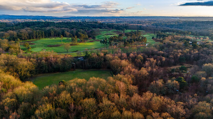 Obraz premium Aerial view of a rural golf course in the late afternoon sunshine