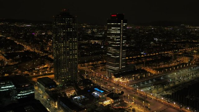 Aerial drone panorama of Villa Olimpica del Poblenou, in the city of Barcelona. Twin skyscrapers of Hotel Arts and Torre Mapfre next to Port Olimpic.	