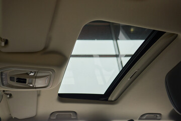 Motor vehicle with sunroof, rear view mirror, and hood