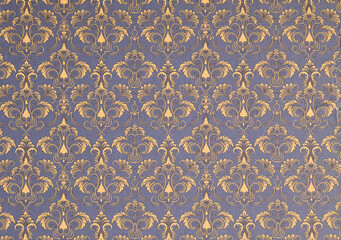 Old wallpaper on the wall. Old wallpaper for texture or background.