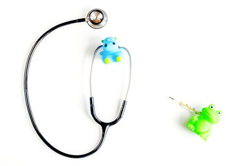 Pediatrics equipment with toys, stethoscope white background top view space for text