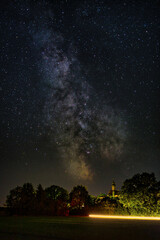 Vertical shot of a beautiful milky way sky over Abbey Andechs, Bavaria, Germany
