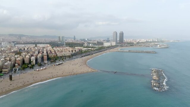 Aerial drone panorama of Villa Olimpica del Poblenou, in the city of Barcelona. Twin skyscrapers of Hotel Arts and Torre Mapfre next to Port Olimpic.