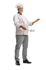 Mature male chef holding a turner utensil