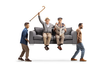 Happy elderly men sitting on a sofa carried by young men