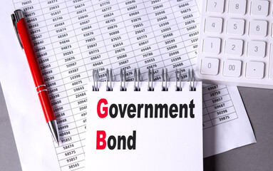 GOVERNMENT BOND text on notebook with chart , pen and calculator