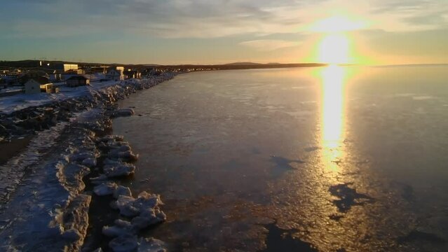 Winter sunset over the ocean in Matane, Quebec, Canada.