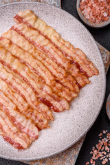Delicious bacon in the form of slices with salt, spices and herbs