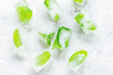 Ice cubes with mint stone background top view