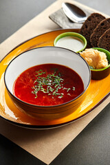 Red borscht with sour cream, black bread and lard with garlic spread