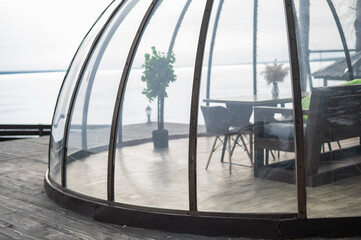 Domed terrace on the bank of a frozen river. 