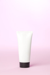 White sunscreen bottle on pink background. Product concept. Sunscreen concept. copy space.