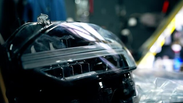 close-up At a service station master auto mechanic parts black headlights