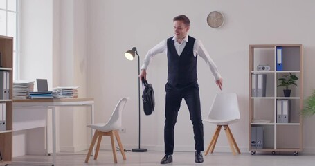 Happy cheerful carefree satisfied man office worker with briefcase celebrating promotion and good paycheck, having fun at end of work day, feeling full of energy, dancing funny TGIF dance and jumping
