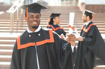 education, graduation and people concept - group of happy international students in mortar boards...