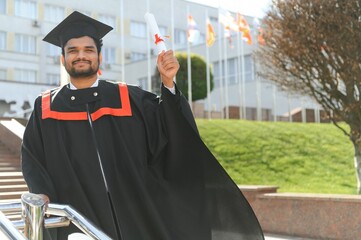 education, graduation and people concept - happy Indian Male graduate student