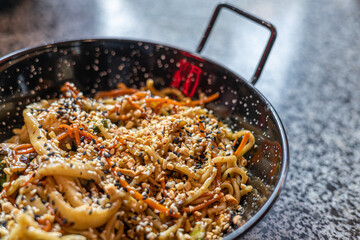 Seafood pasta. A plate of tagliolini with mussels, shrimps, clams and squids.Sea food pasta dinner, Noodle paella. Typical Catalan dish made with noodles and seafood