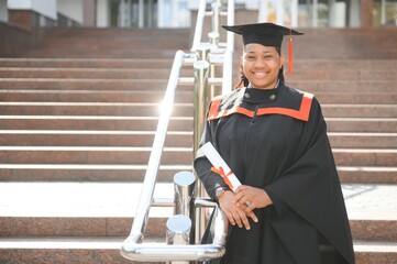 pretty african university graduate at graduation ceremony