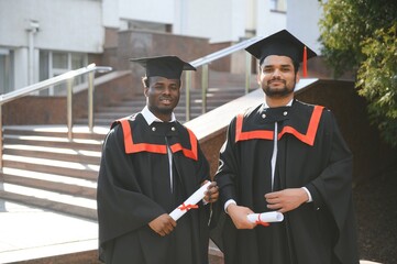 Happy boys students university graduates. Multiracial students