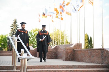 Happy boys students university graduates. Multiracial students