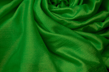 Green fabric draped on the backrest