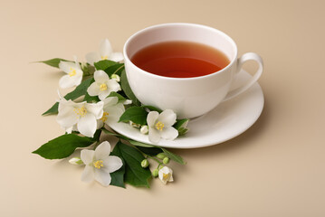 A white tea cup with a jasmine flower