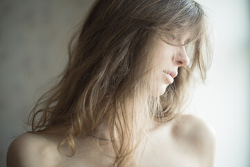 portrait of a girl on a light background long blond hair light skin