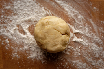 Top view of pie dough rolled into a ball on a floured board